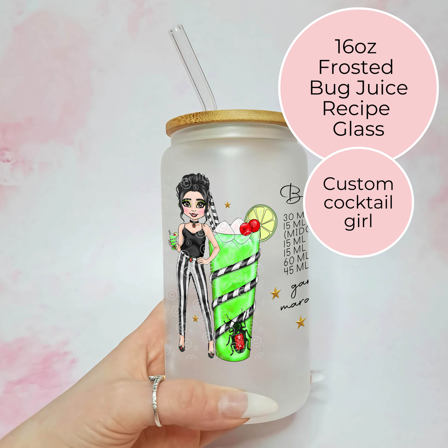 Frosted bug juice recipe glass with a custom illustration of a girl and cocktail, held by a hand.